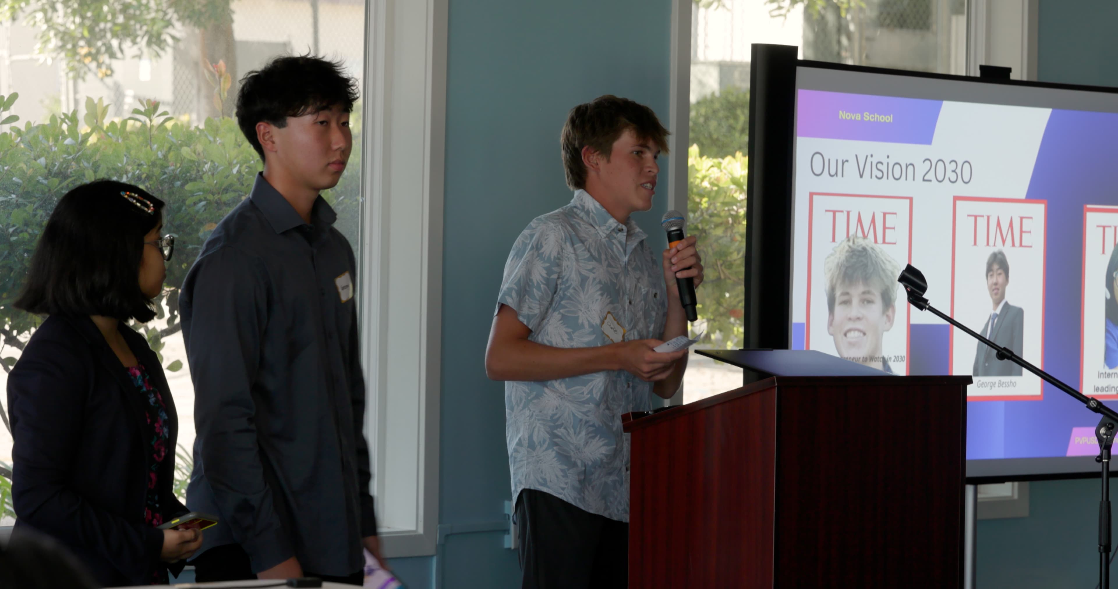 Students presenting on stage