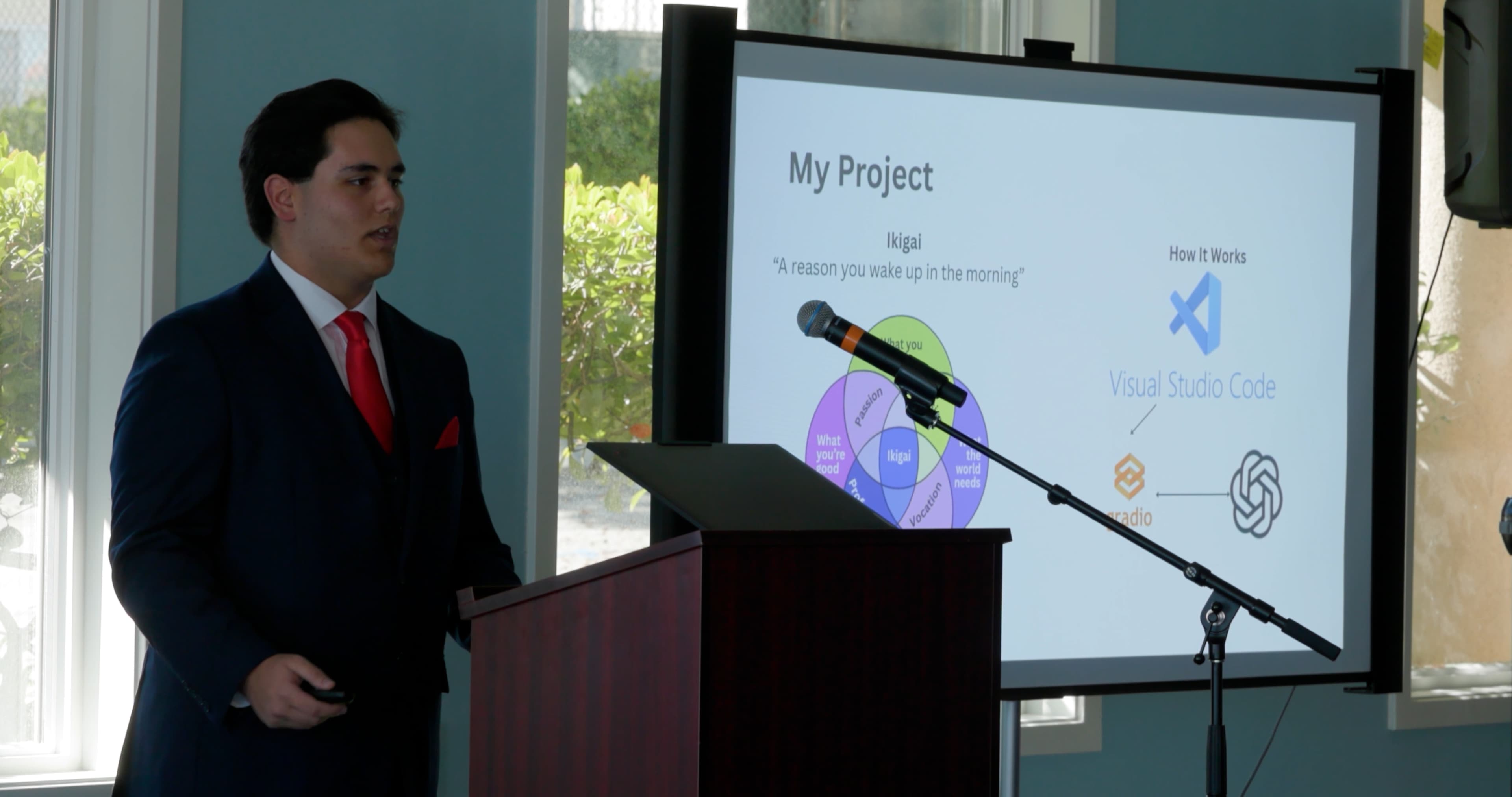 Joshua presenting on stage